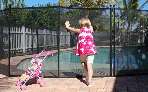 Girl Pushing on Pool Fence