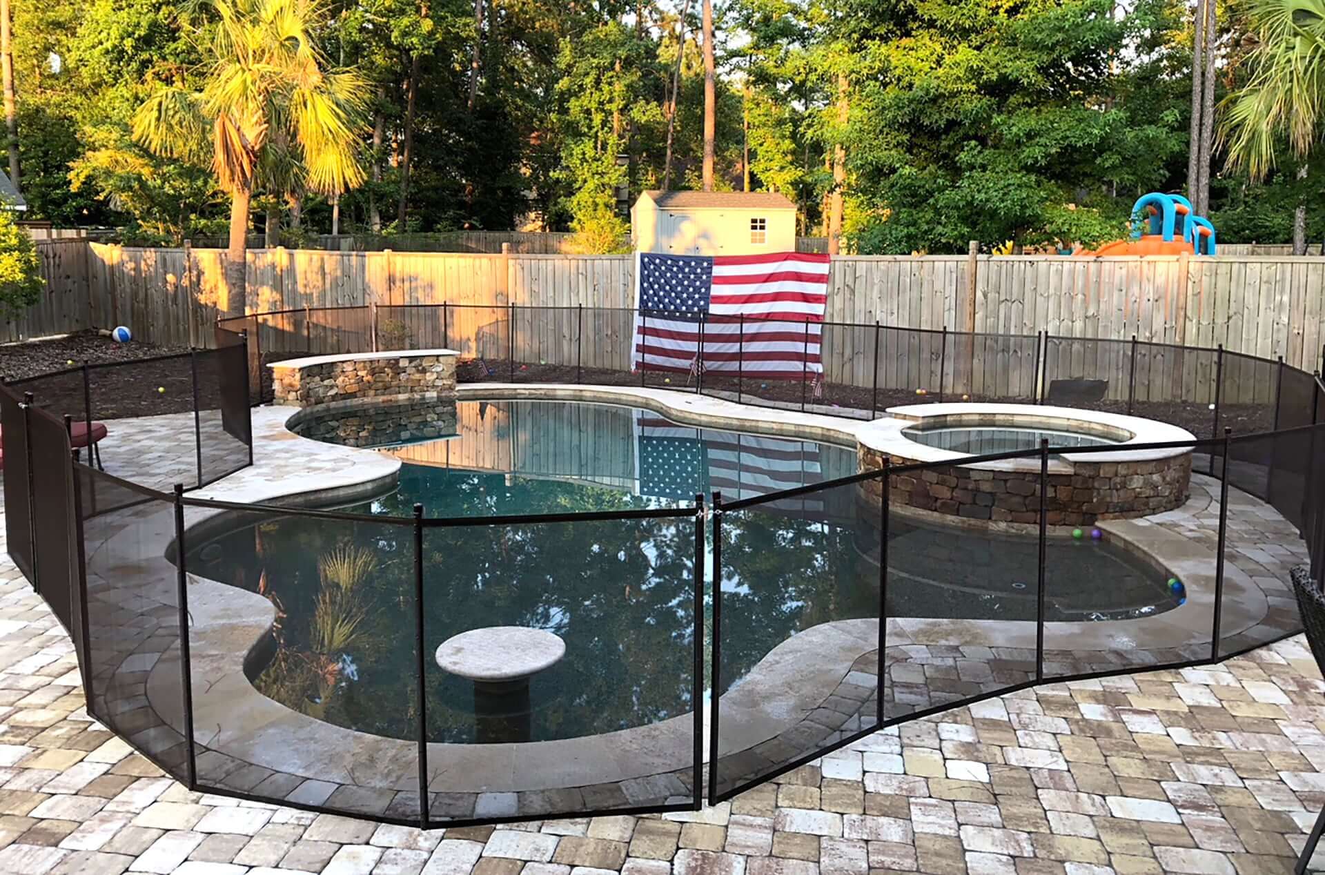 Curved Mesh Pool Fence with American Flag